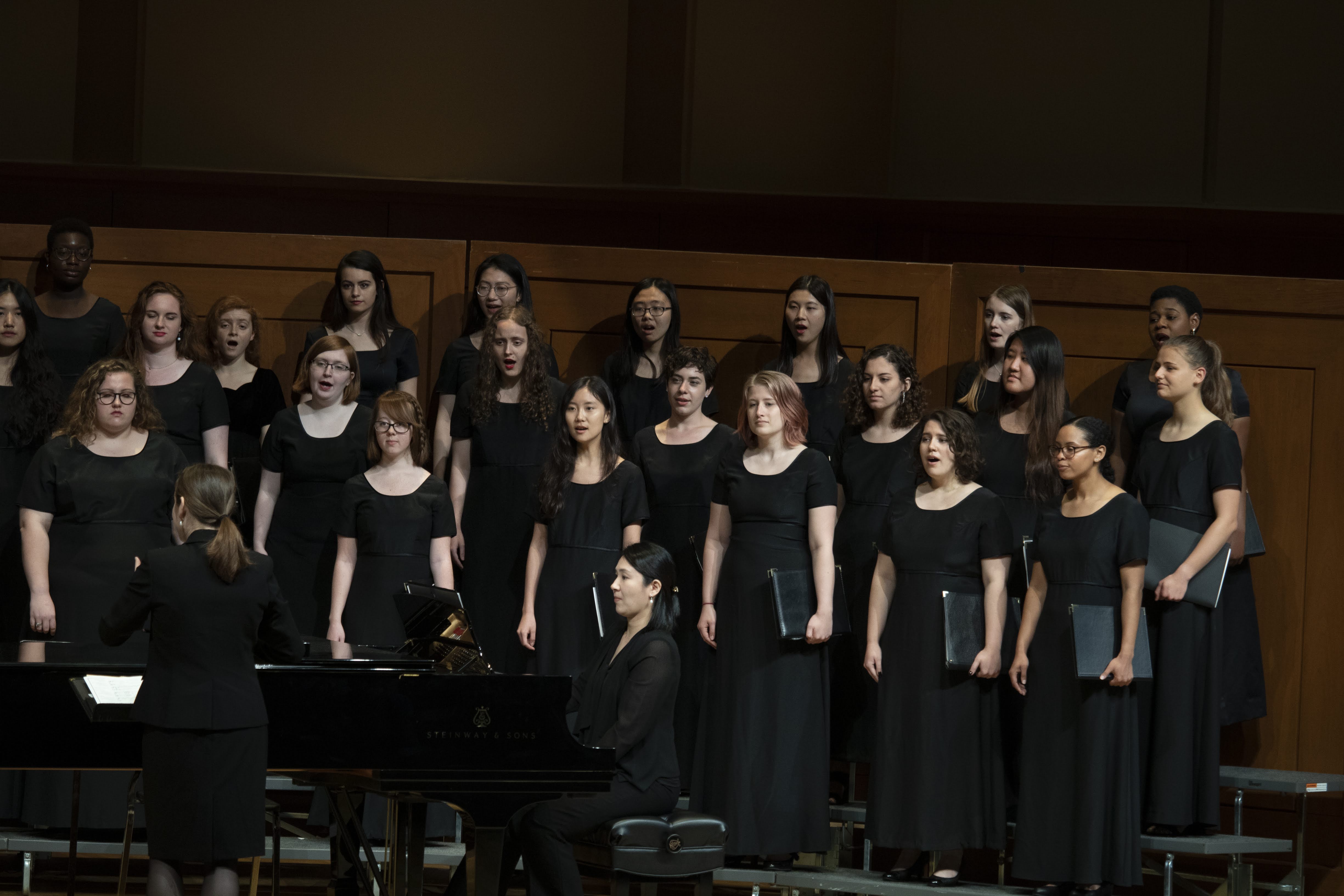 Laura Alexander conducts the UNC Glee Club, Soprano/Alto voices on Moeser Auditorium stage.