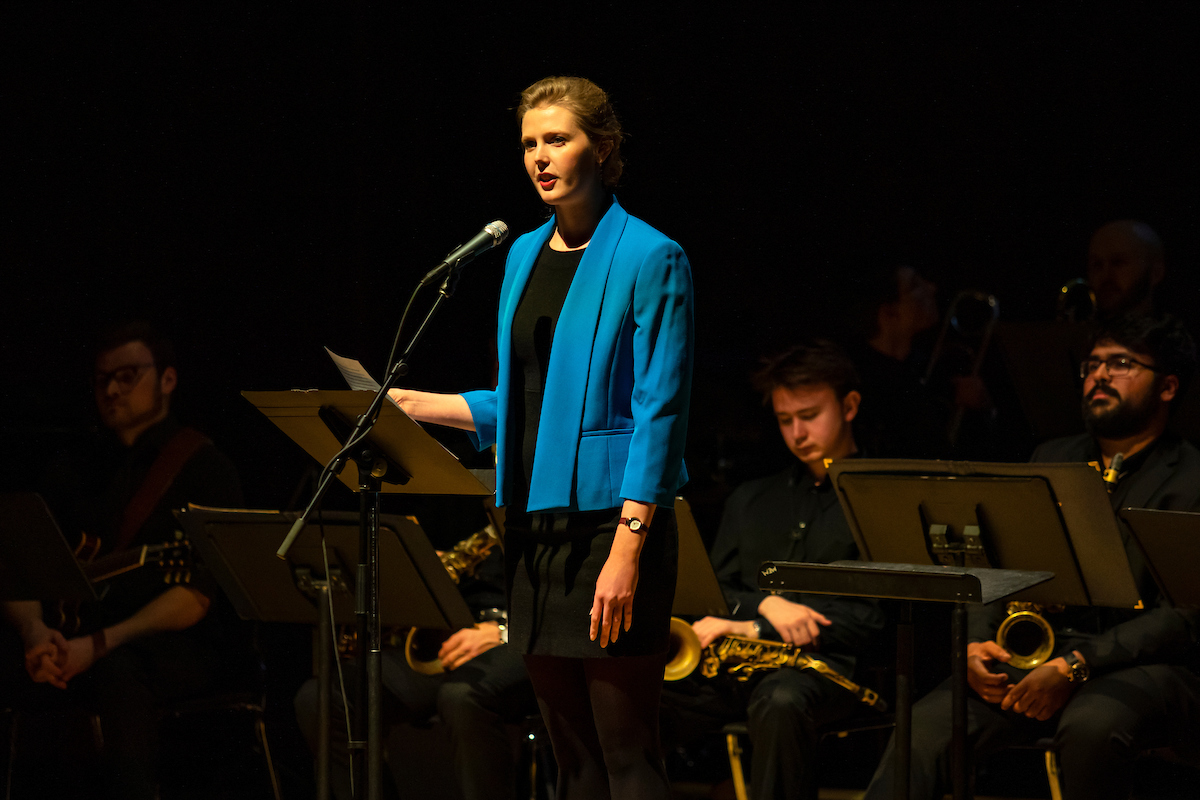 Sarah Tomlinson presents at the Spectrum Concert in February 2019.