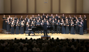 Screenshot of Susan Klebanow conducting Carolina Choir in the world premiere of Frazelle's Songs of War in December 2019.