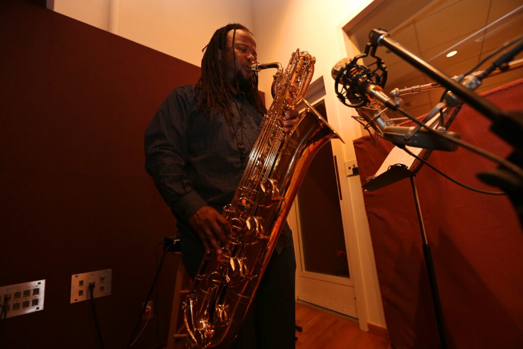 Rahsaan Barber plays saxophone in recording studio for his latest album.