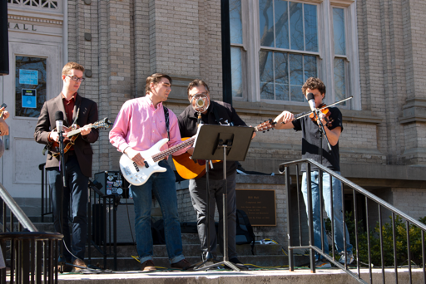 Four members on the Carolina Bluegrass Band perform on the steps of Hill Hall