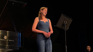 Julia Holoman smiles on stage at the Aspen Music Festival