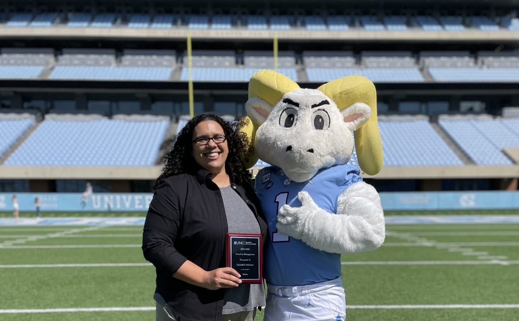 El Fisseha stands with Ramses on the field in Kenan Stadium.