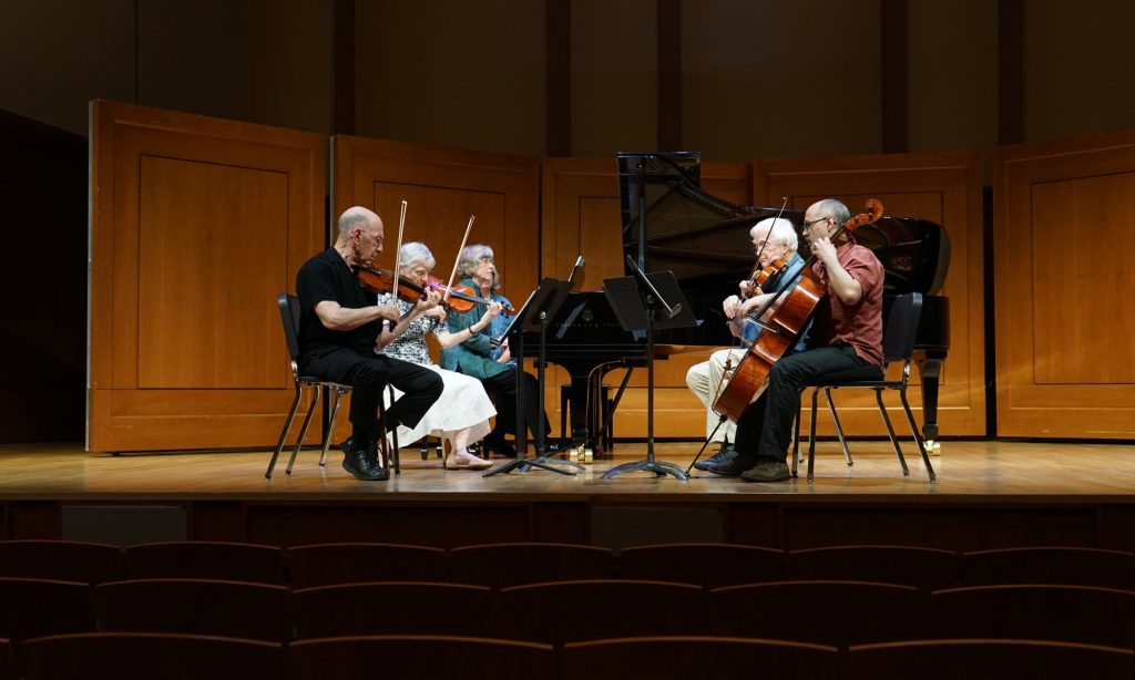 A chamber ensemble performs together on Moeser Auditorium stage.