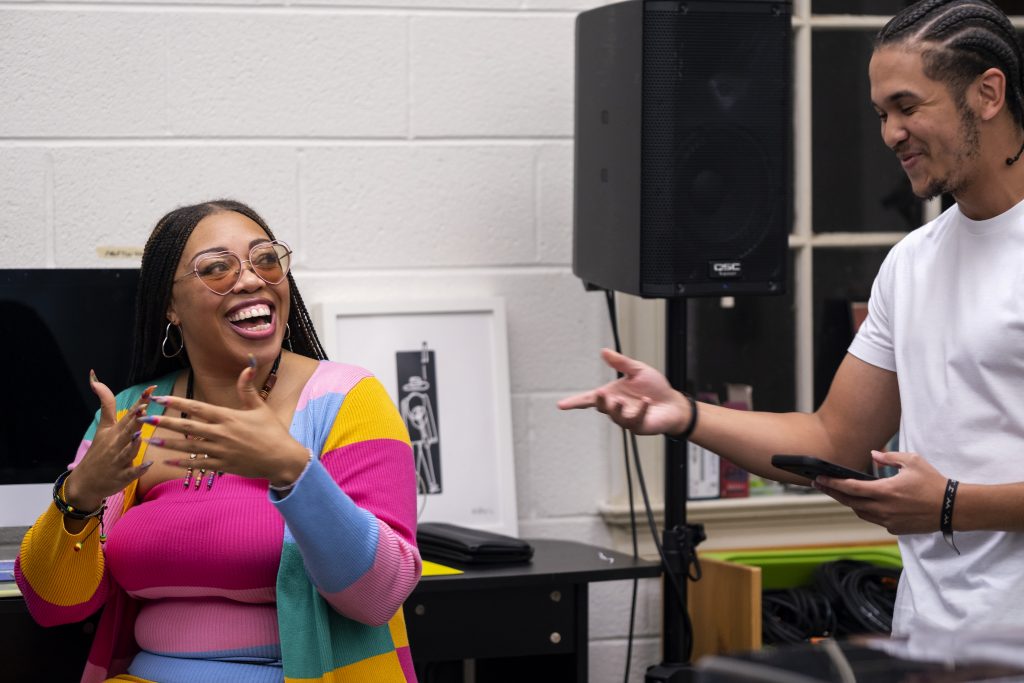 Maya Shipman smiles as she converses with a student in the Hip Hop Ensemble.
